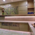 Stylish modern kitchen featuring green cabinets and minimalist design.